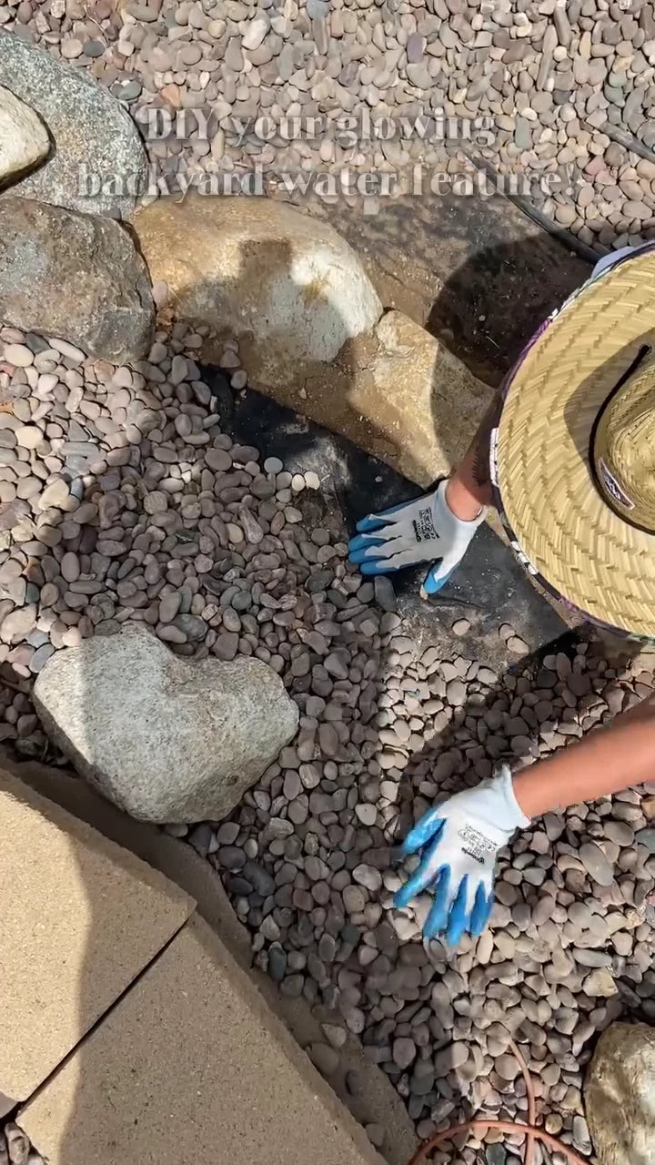 Gloved hands prepare the gravel corner.